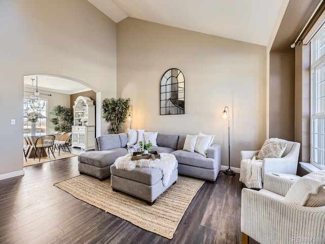 living room with dark hardwood / wood-style flooring and high vaulted ceiling