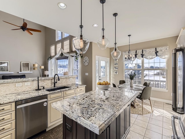 kitchen featuring sink, light tile patterned floors, dishwasher, a kitchen island, and light stone countertops