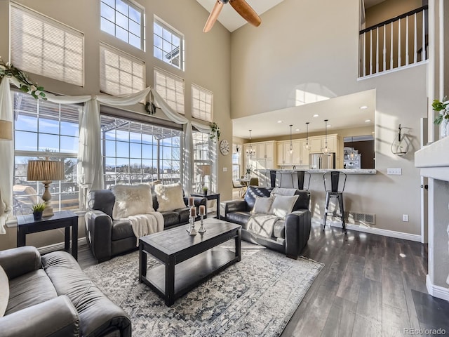 living room with dark hardwood / wood-style floors and a healthy amount of sunlight