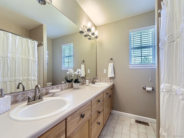 bathroom featuring vanity, tile patterned floors, and toilet