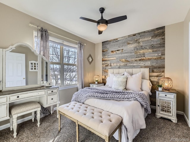 bedroom featuring carpet floors, ceiling fan, and wood walls