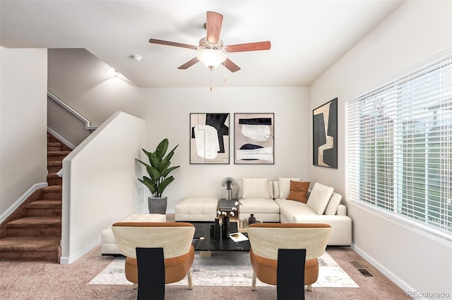 living room featuring ceiling fan and light colored carpet