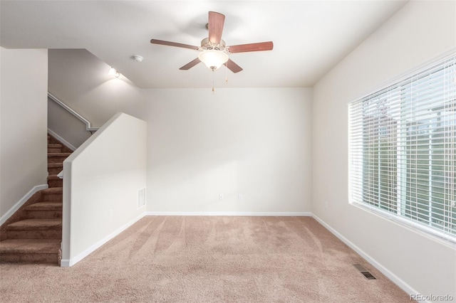 carpeted empty room featuring ceiling fan