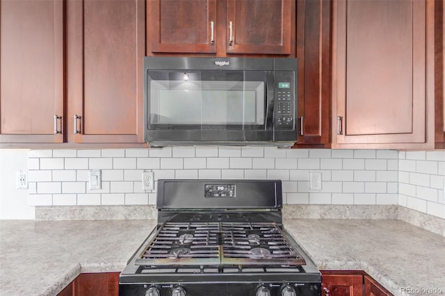 kitchen with backsplash and black appliances