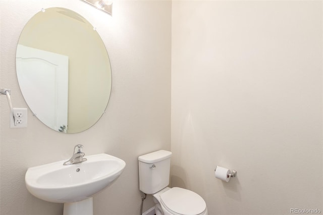 bathroom featuring sink and toilet