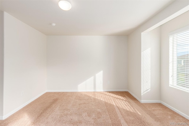 empty room featuring light carpet and a wealth of natural light