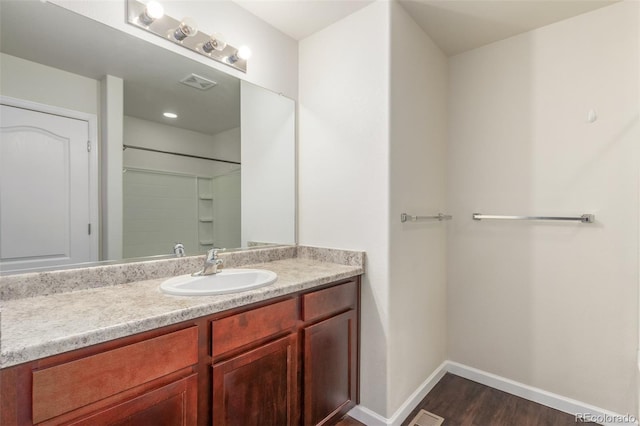 bathroom with vanity and hardwood / wood-style floors