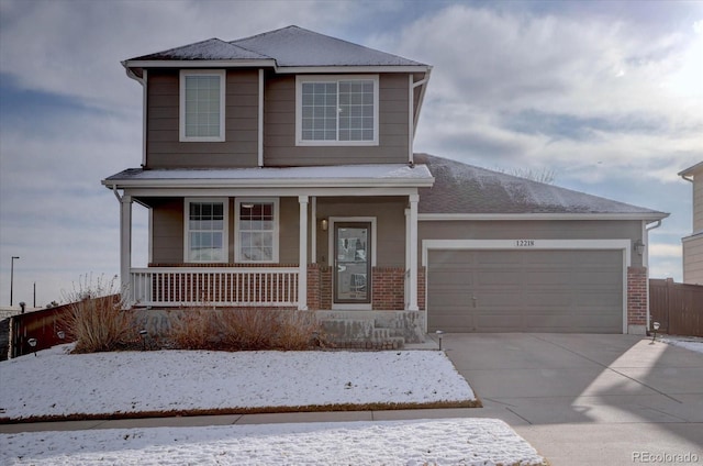 view of front of house featuring a garage, covered porch, brick siding, and concrete driveway