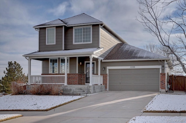 view of front facade with driveway, a garage, a porch, and brick siding