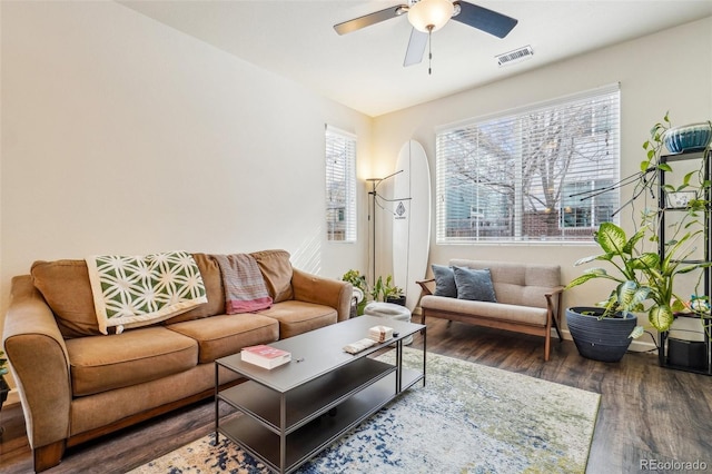 living area featuring ceiling fan, wood finished floors, and visible vents