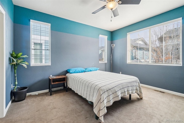 bedroom with carpet floors, visible vents, baseboards, and ceiling fan