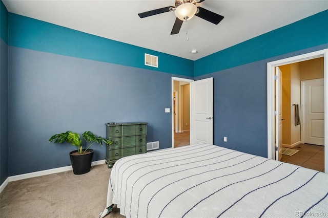 carpeted bedroom with baseboards, visible vents, and a ceiling fan