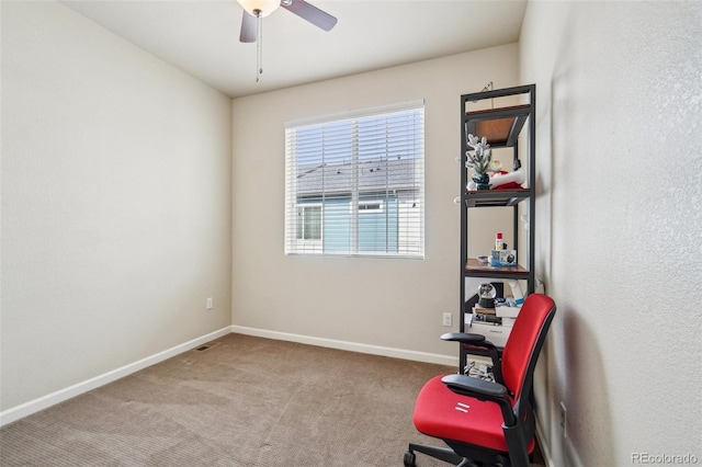 living area with carpet floors, baseboards, and a ceiling fan