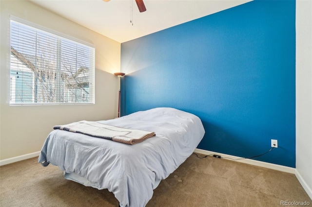 bedroom with ceiling fan, carpet floors, and baseboards