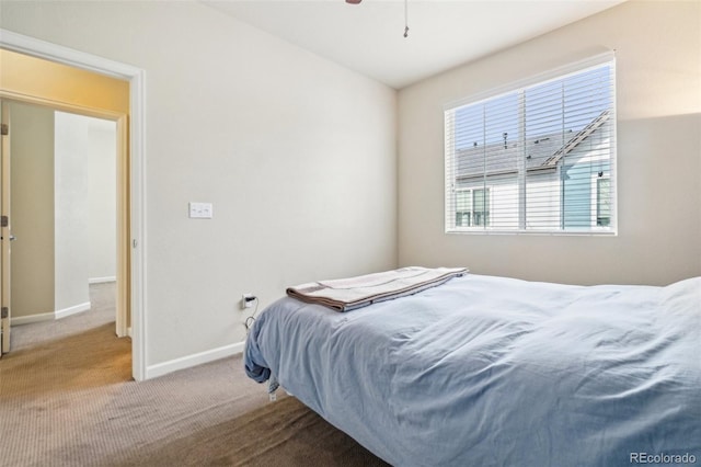 bedroom with carpet floors and baseboards