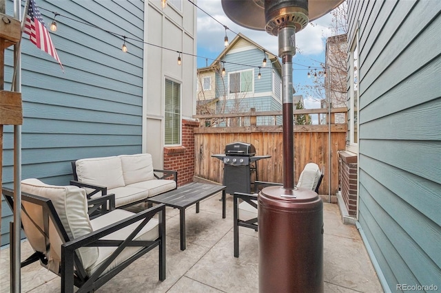 view of patio with fence, grilling area, and an outdoor hangout area