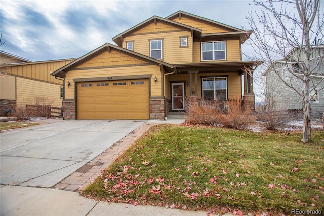 craftsman inspired home with a garage and a front yard