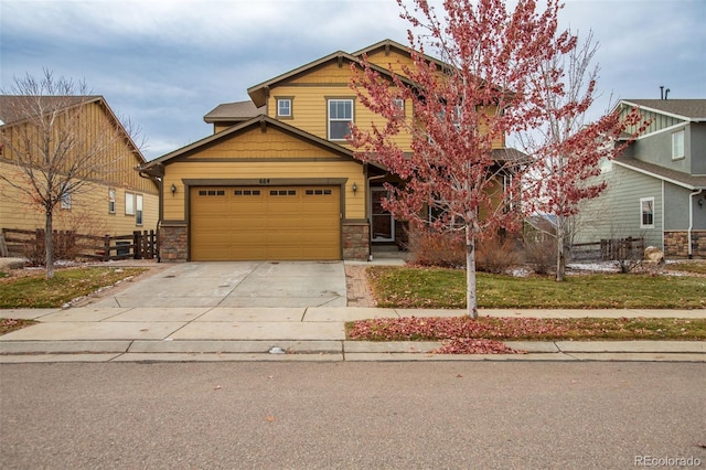 craftsman-style house featuring a front yard and a garage