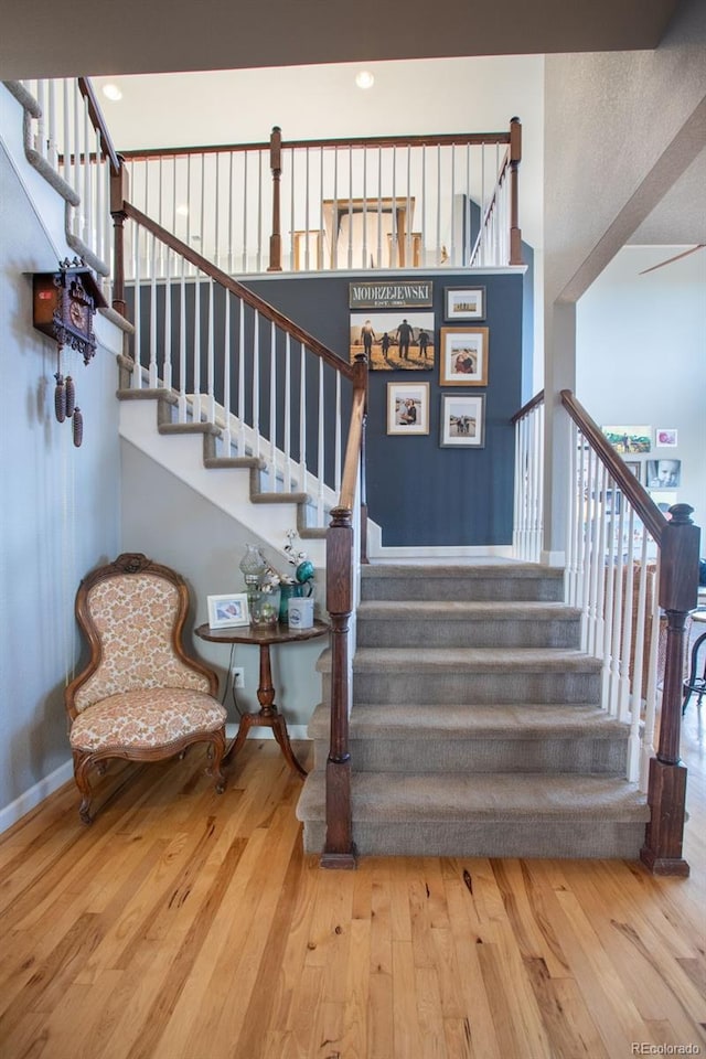 stairway featuring hardwood / wood-style flooring and a wealth of natural light