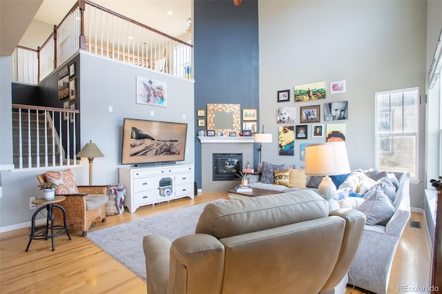 living room with a high ceiling and hardwood / wood-style floors