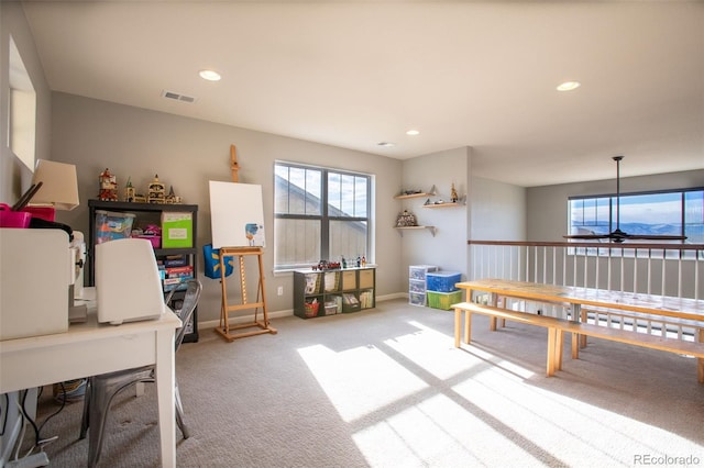 recreation room with carpet floors and ceiling fan