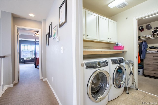 washroom with cabinets, light carpet, washer and clothes dryer, and ceiling fan