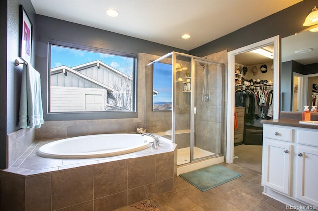 bathroom featuring tile patterned floors, vanity, and separate shower and tub