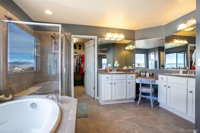 bathroom featuring plus walk in shower and vanity