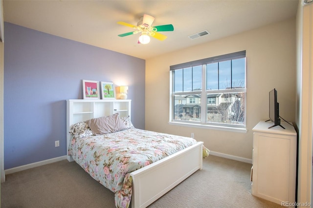 bedroom with ceiling fan and light colored carpet