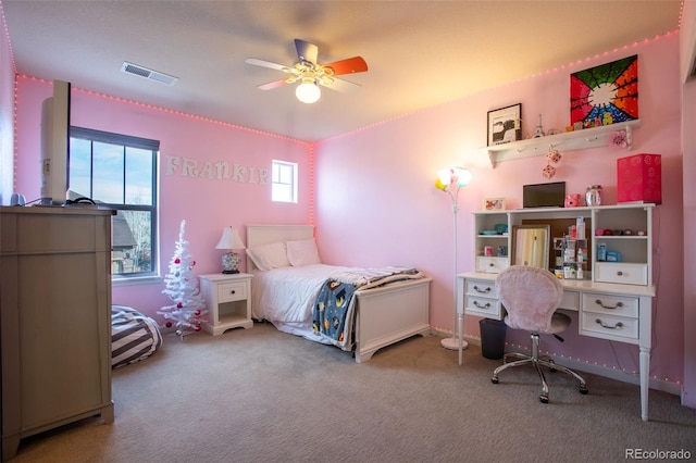 carpeted bedroom featuring multiple windows and ceiling fan