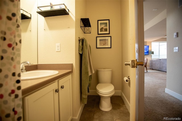 bathroom featuring tile patterned flooring, vanity, and toilet