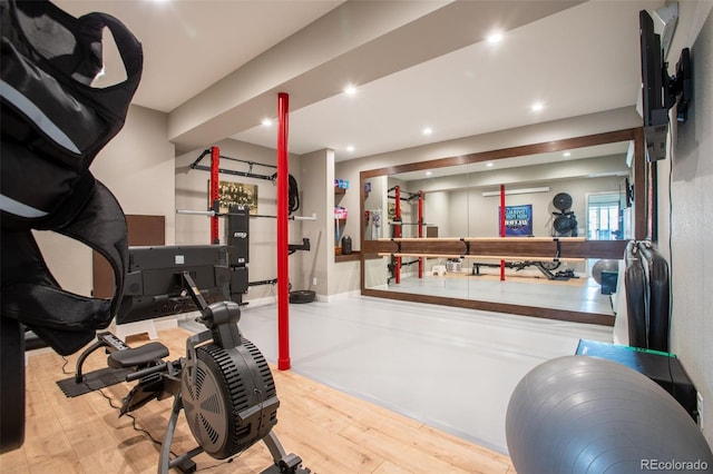 exercise room with light wood-type flooring