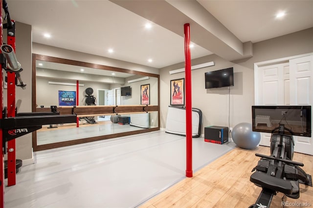 exercise room with hardwood / wood-style floors