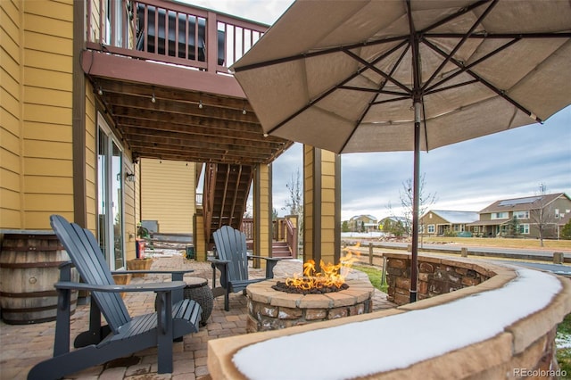 view of patio / terrace featuring a balcony and an outdoor fire pit