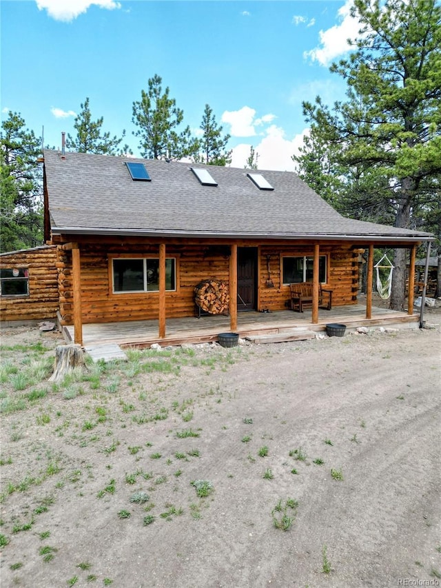 148 Wakonda Ln, Hartsel, CO 80449 - back of property with log exterior, covered porch, and a shingled roof