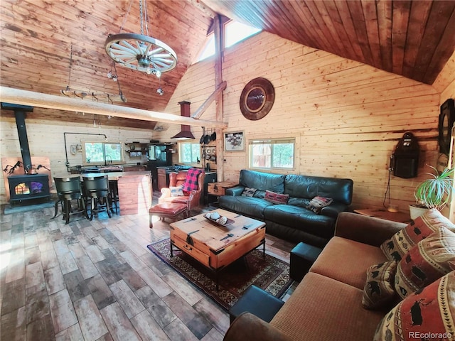 148 Wakonda Ln, Hartsel, CO 80449 - living area with wood walls, high vaulted ceiling, healthy amount of natural light, a wood stove, and wood ceiling