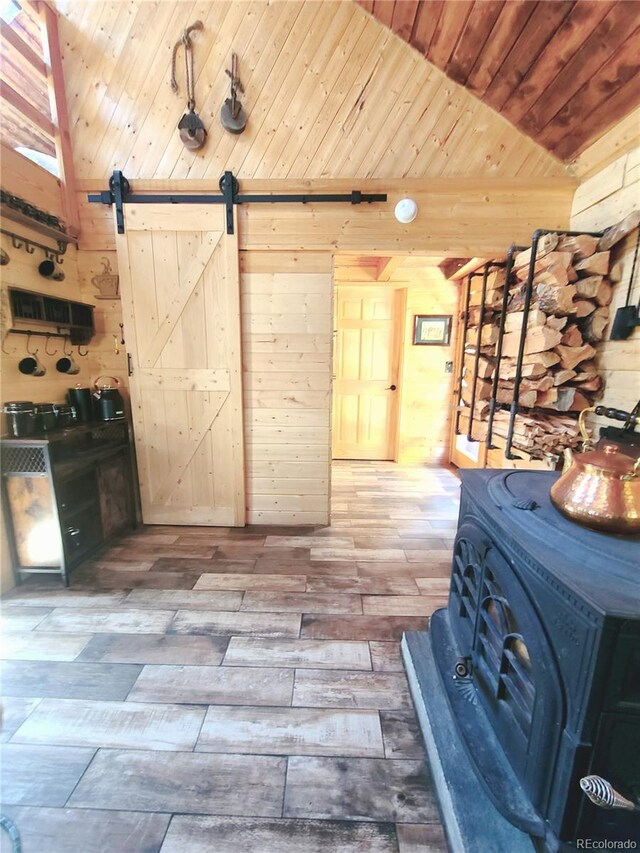 148 Wakonda Ln, Hartsel, CO 80449 - unfurnished bedroom with wood walls, a barn door, and hardwood / wood-style floors