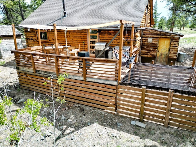 148 Wakonda Ln, Hartsel, CO 80449 - back of house featuring log siding, a shingled roof, and a deck