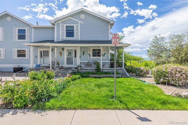 6260 Everett Ct Unit D, Arvada, CO 80004 - view of front facade featuring a front yard and a porch