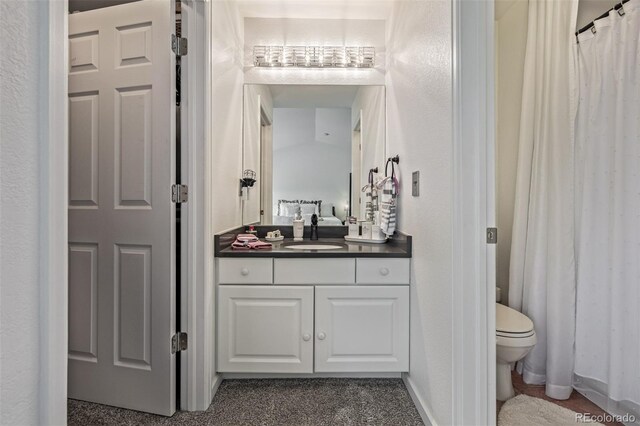 6260 Everett Ct Unit D, Arvada, CO 80004 - bathroom featuring toilet, vanity, and curtained shower