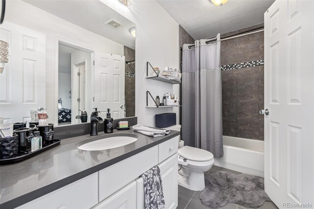 6260 Everett Ct Unit D, Arvada, CO 80004 - full bath with tile patterned floors, toilet, vanity, and shower / tub combo