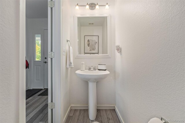6260 Everett Ct Unit D, Arvada, CO 80004 - bathroom with wood finished floors, baseboards, and a textured wall