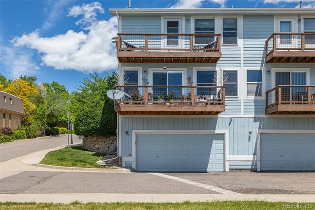 6260 Everett Ct Unit D, Arvada, CO 80004 - view of property featuring a balcony, a garage, and driveway