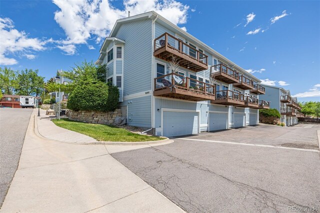 6260 Everett Ct Unit D, Arvada, CO 80004 - view of building exterior with an attached garage and driveway