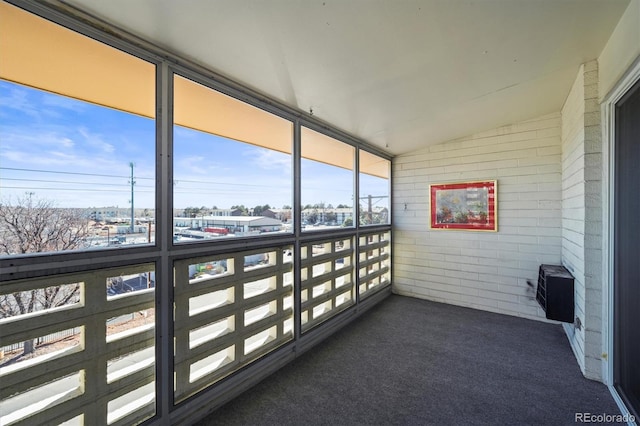 unfurnished sunroom featuring lofted ceiling