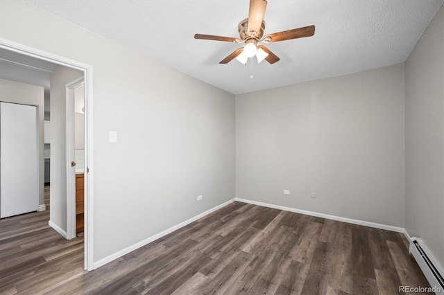 spare room with dark wood-style floors, a baseboard radiator, ceiling fan, and baseboards