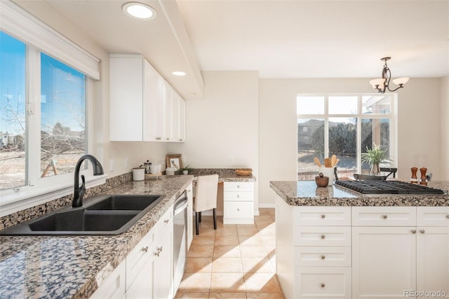 kitchen with white cabinetry, dishwasher, and sink