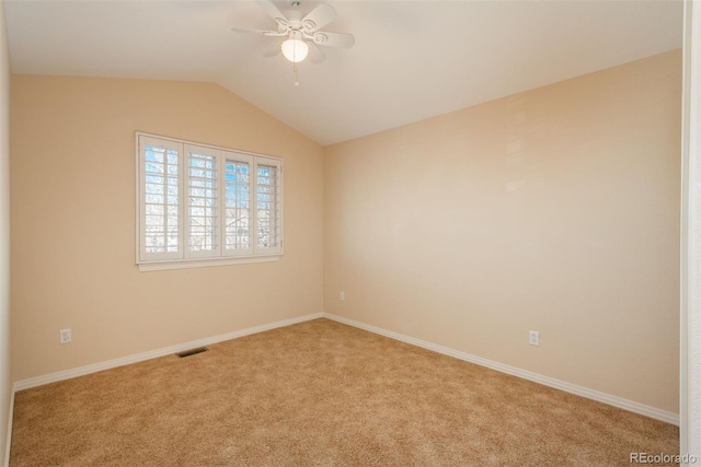 spare room featuring vaulted ceiling, light carpet, and ceiling fan