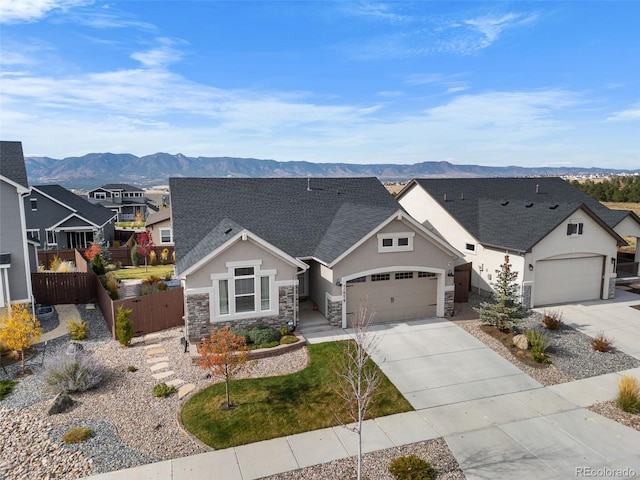 view of front of home with a mountain view and a garage