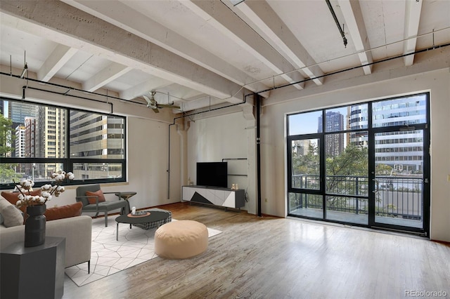 living area featuring wood finished floors and beamed ceiling